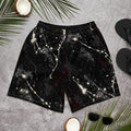 Front view of black athletic shorts with white and red paint splatter and a small ATB logo, laid flat on a gray surface.