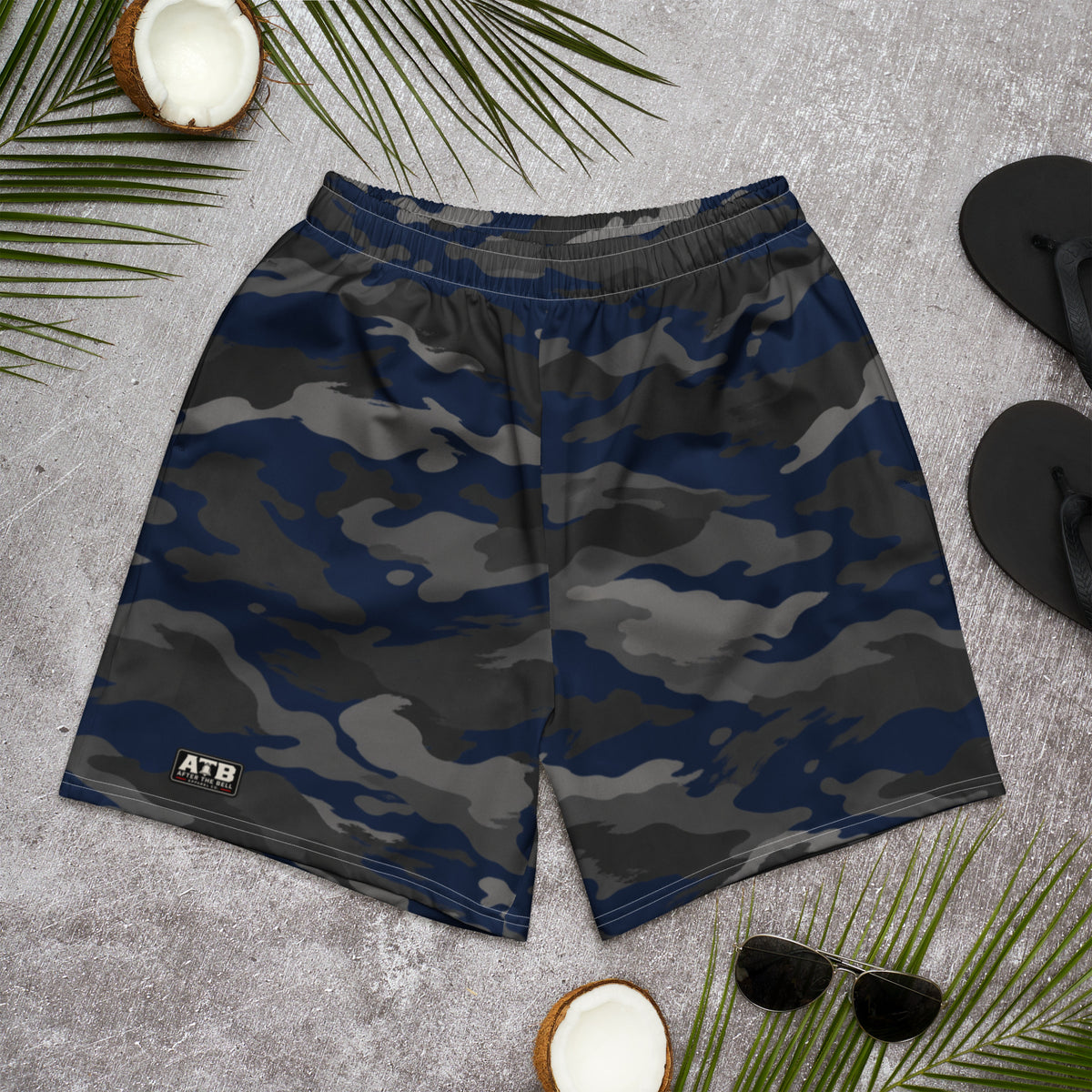 Front view of navy, charcoal and black camouflage athletic shorts with a small ATB logo, laid flat on a gray surface.