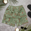 Camo green athletic shorts with cream paisley and red bandana accents, laid flat on a gray surface.
